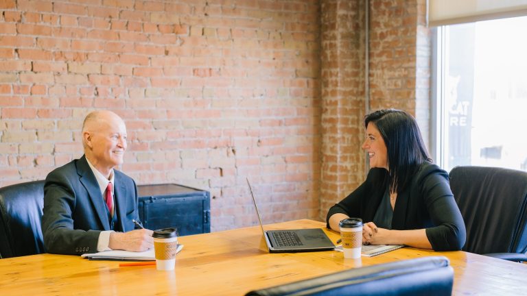 man and woman talking inside office